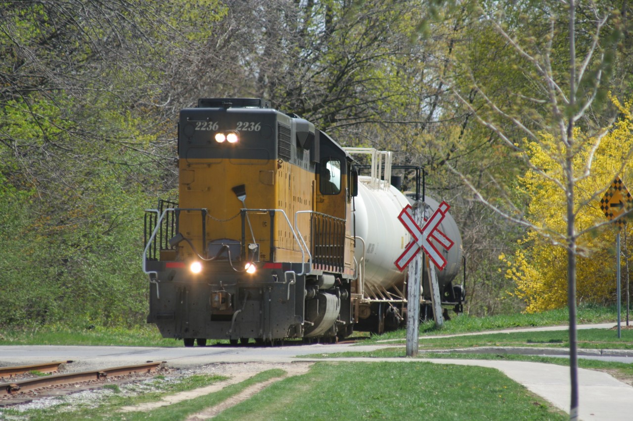 Goderich-Exeter Railway (GEXR) train X580 with LLPX GP38-2 2236 leads tank cars at it crosses Willow Street on the Waterloo Spur, as it approaches Uptown Waterloo on a pleasant spring morning. Train X580 is destined for Elmira where it will service the chemical facilities, before returning to Kitchener later in the morning.