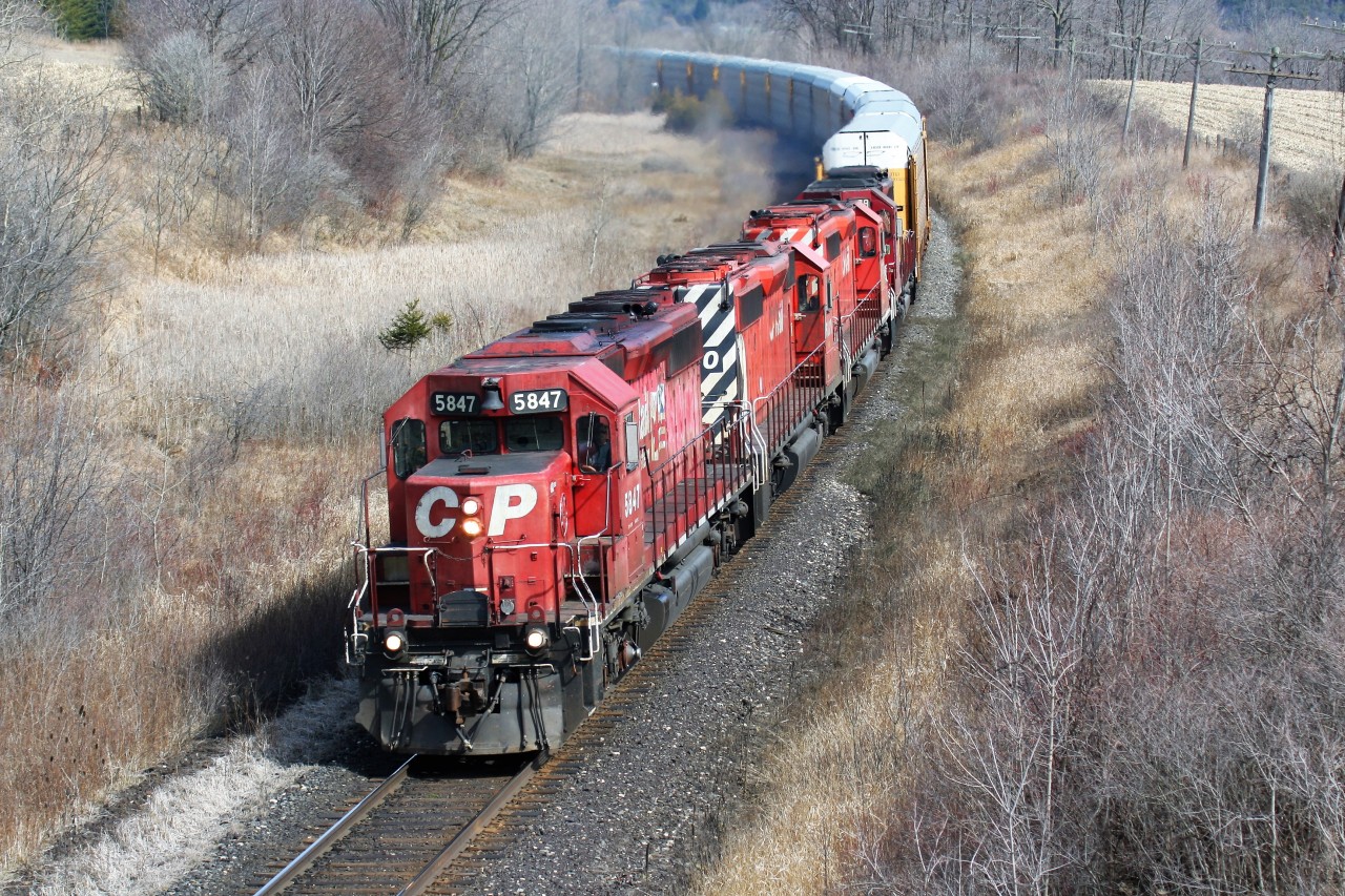 A quartet of SD40-2's in various paint schemes lead a westbound Canadian Pacific train as it approaches the Highway #2 crossing just west of Woodstock on the Galt Subdivision.
