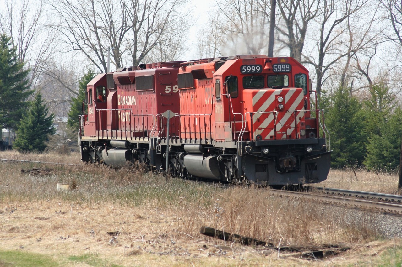 Canadian Pacific train T69 heads westbound through Innerkip, Ontario with only light power on a spring morning. The consist includes; SD40-2's 5943 and 5999.