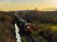 CN 3119 leads eastbound train 406, as they approach Sussex, New Brunswick, at sunset. 