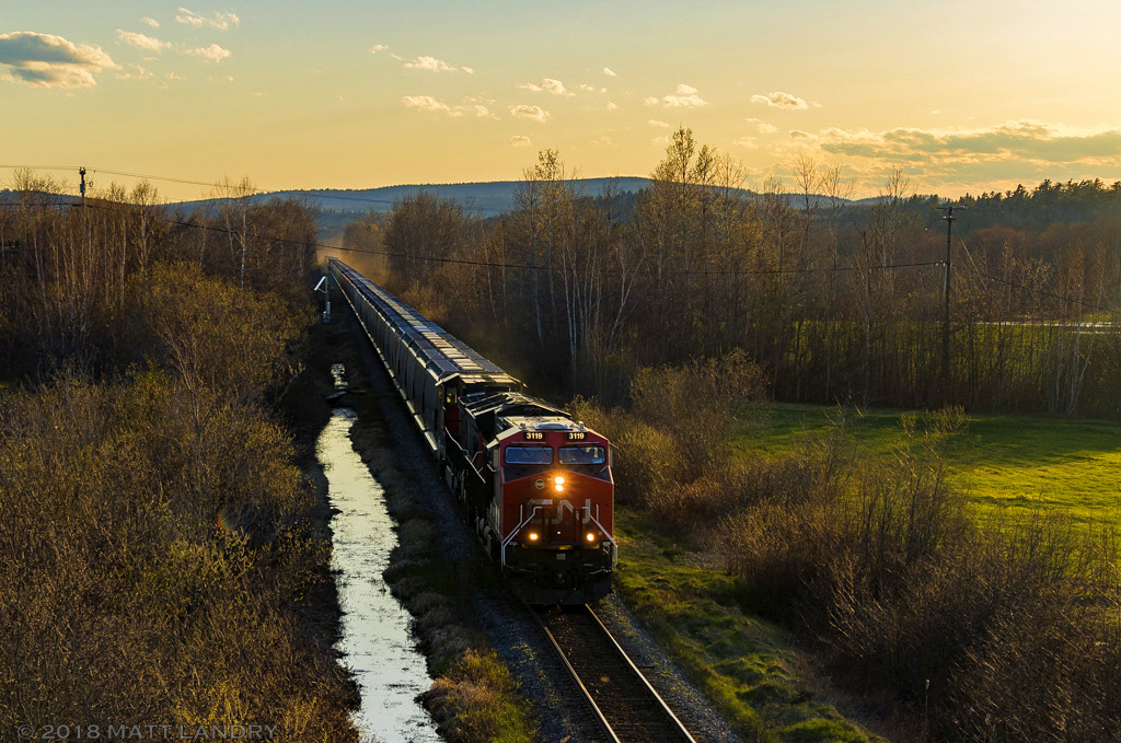 CN 3119 leads eastbound train 406, as they approach Sussex, New Brunswick, at sunset.