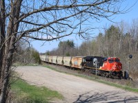 The sight of a potash train in Southern Ontario is definitely a rare occurrence. Here we see a re-routed train #781 passing the still mainly dormant landscape at the well known railfan hangout at Scotch Block, Mile 30 of the Halton subdivision. The detour was due to a wash out in Northern Ontario, and the train also had an ES44AC as mid train DPU.