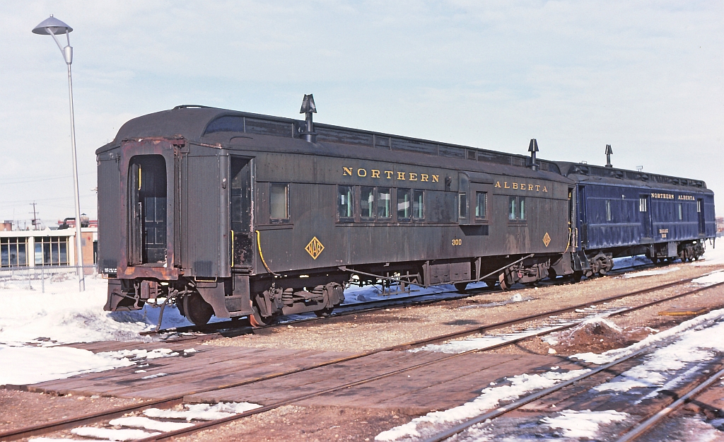 NAR 300, a combine or comboose take your pick. This car was built in 1899 and was still in regular service when this image was taken, 1982. It was used on a the NAR  and way freight job north of Edmonton. Generally between trips it was serviced and stored at what we called the "coach yard" at the downtown CN / Via station. On this day it was coupled to NAR 1602, built by Pullman in 1925.
