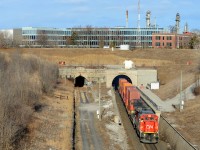 I find this spot a difficult one to shoot, what do you include? What angle is the train really at, as there's a bit of a banked curve as well I'm well above the train on a pedestrian overpass. Also, there are poles for security cameras and animal noises used to scare away the things that fly or walk into tunnels (which set off alarms). And I really don't want to block those really neat tunnels with a pole. So this is what I did on April 1st - I include most of the Imperial Oil buildings and what makes it for me is the leader - I simply saw a signal for an eastbound and waited (not too long) for it. A very clean used dash 8 in the lead makes this a nice catch in my books. Time was 0900 and the sun is quite nice in the spring in the morning - not quite so in the late summer days, as you have to let it swing around just enough to cast no shadows, but if you go at the right time there's usually a few eastbounds in the morning, most often though they pass just before dawn.