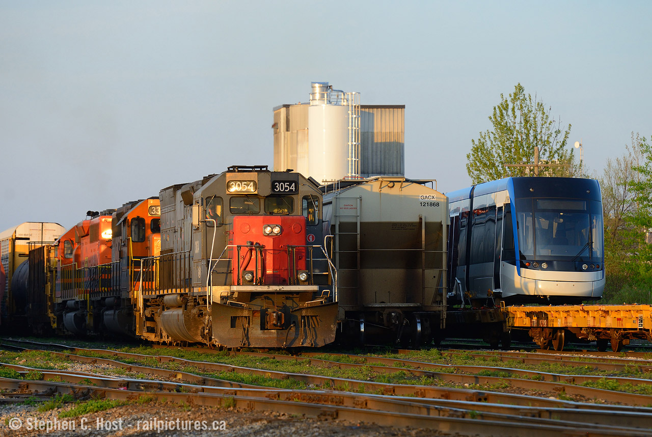 GEXR has played a large role in the ION LRT by delivering the new cars to the Commonwealth Plywood siding in Waterloo. The cars don't sit for very long as they are desired to be delivered very quickly. Imagine my surprise to head to Kitchener to find both 431 and a LRT sitting in the yard, mind you, by this time of night (8 PM!) 431 is long off duty and a new crew from Stratford has taxied over to bring 431 across to Stratford. 584 would deliver the LRV that evening and was switching the yard as I took this photo. At any rate, an ex SP SD45 and a Bombardier Flexity side by side is an odd pairing to say the least.