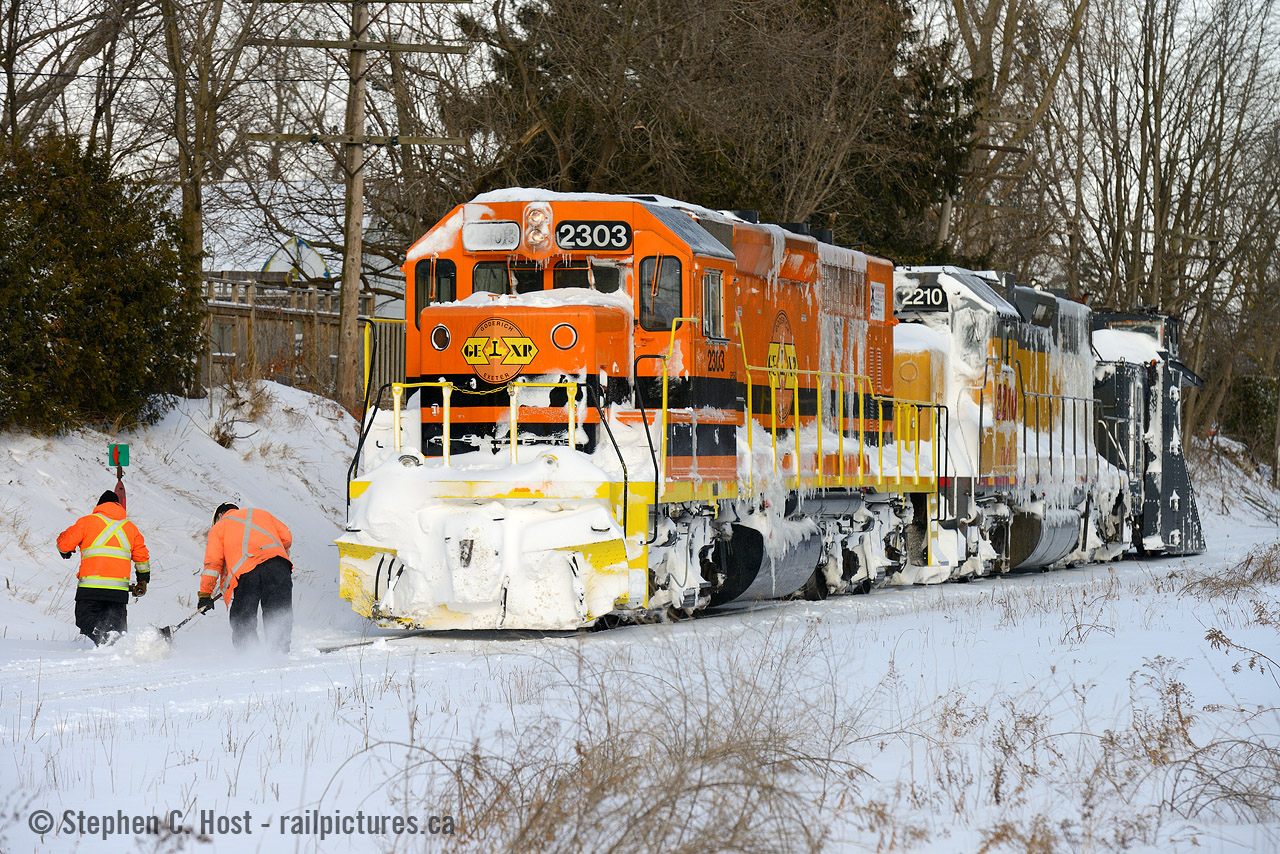 So, how about that heat? In this photo GEXR's plow crew (from the MOW team) are cleaning out the switch for the east leg of the wye as they have to turn the train to plow back west to Stratford, and you can see the battle was already quite good. We had a number of plow runs in 2014 on the GEXR mainline between both Stratford and London, and toward Guelph , not to mention dozens of plow runs to Goderich. Mostly memories now,  as it's quite rare for GEXR to use their plow to Goderich, the only saving grace is we have yet to see winters as bad as they were in 2014 and 2015. The last three winters (2016, 2017 and 2018) all started with a bang (Often requiring a single plow run, by someone - GEXR, CN, or OSR) but ended with a fizzle as the precipitation and cold did not come to pass as the farmers almanac would have had you believe. I'll share more of these memories over the years, the number of plow runs I shot in those two years was upwards of 40! Technology and age of equipment may threaten the use of a wedge plow but when mother nature is at her worst there is only one time tested solution, and I'm grateful to have had the opportunity to do this so close to home. GEXR's snow removal crews made it look easy but I know a lot of hard work and knowledge goes into their success. Cheers to the GEXR gang!