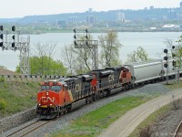 CN train 331 has entered its most characteristic section of track, the Cowpath, as it departs the eastbound Oakville Sub at Hamilton Junction, following this side of the wye to join the westbound Dundas Sub. CN 2319 is working hard while CN 8823 is taking it easy, apparently out of order and shut down. <br> On the far side of Burlington Bay the west end of Hamilton can be seen - at the right near the water is Stuart Street Yard which this train had passed a few minutes previously. <br>
Of interest are the old junction signals that continue in service, and the new signals that will eventually replace them. <br>
A group of us who regularly railfan in this area agreed Train 331 had not been heard of in a very long time; the word is that that it is reinstated.  