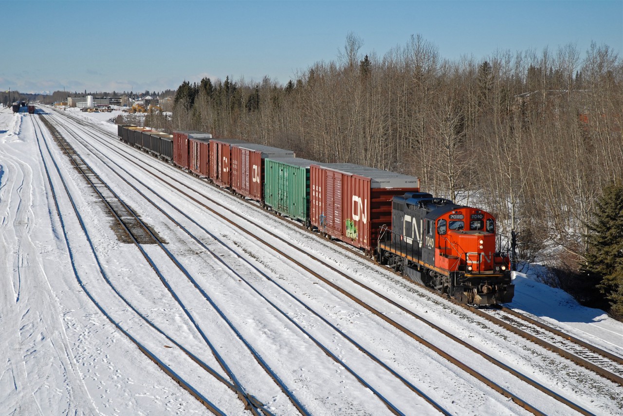 On a crisp March day in Edson Alberta, CN 7040 makes it's way down the main to work a couple industries on the east end of town.