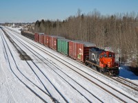 On a crisp March day in Edson Alberta, CN 7040 makes it's way down the main to work a couple industries on the east end of town. 