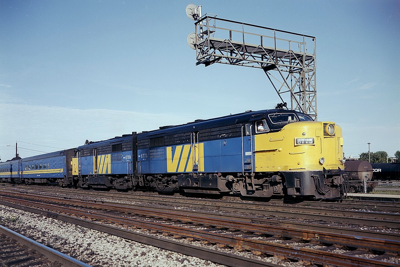 I'm not saying every day featured a passenger train with such nice power up front, but it happened often enough to keep us fans coming out for more. Especially VIA #75, for it was usually the largest train of the day, it stopped at Burlington West station (pictured) and the sun angle was always great. This shot has a lot of 'zap' to it, as I elected to shoot the image with Vericolor III ISO 160 sheet film loaded in my old 4x5 Speed Graphic. The setting was at 400 F8. From purchasing the film and the resulting 8x10 print I had made, I was out $10, which back in 1986 was a lot of dollars, but I haven't regretted coughing up for a single shot that worked out as well as this. Power is 6773 and 6769.