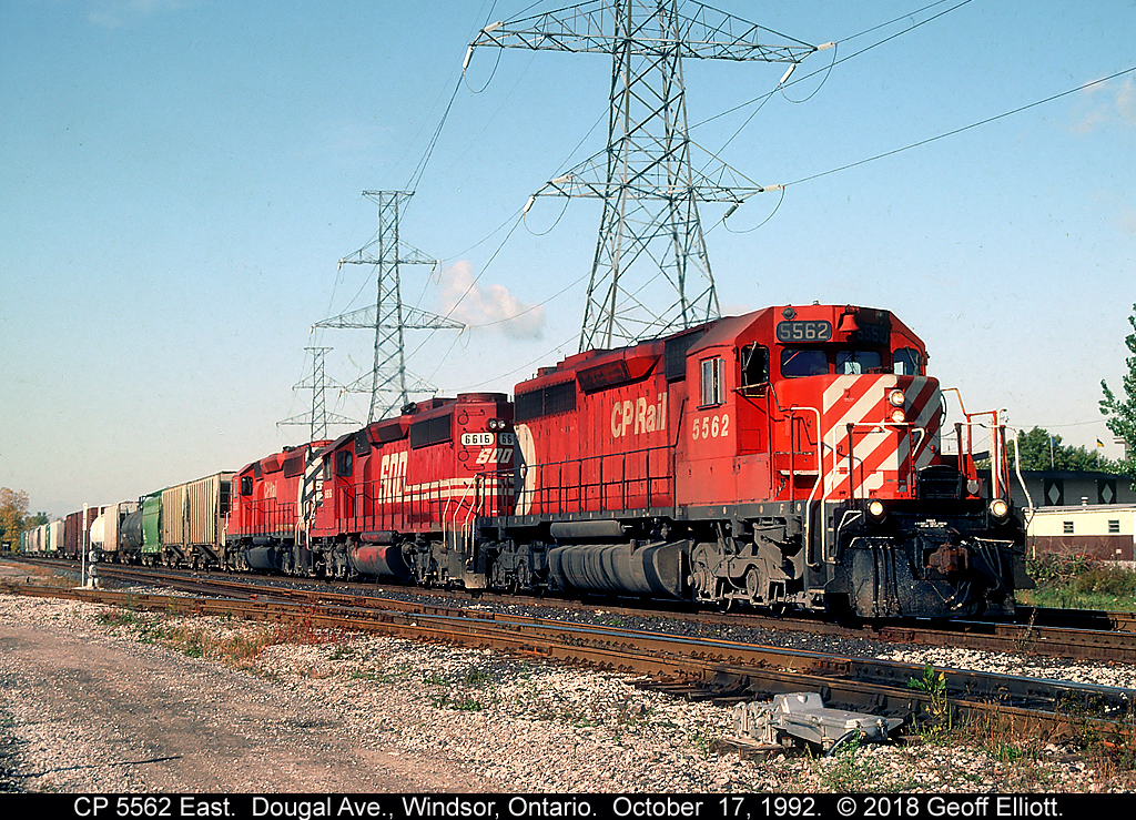Seeing Red.....  CP SD40 #5562 leads a candy apple red SOO SD40-2 #6616, and a sister CP SD40-2 at Dougal Ave in Windsor, Ontario.  It's October 17, 1992 and after a new crew boards the train they'll get rolling and highball east out of town.