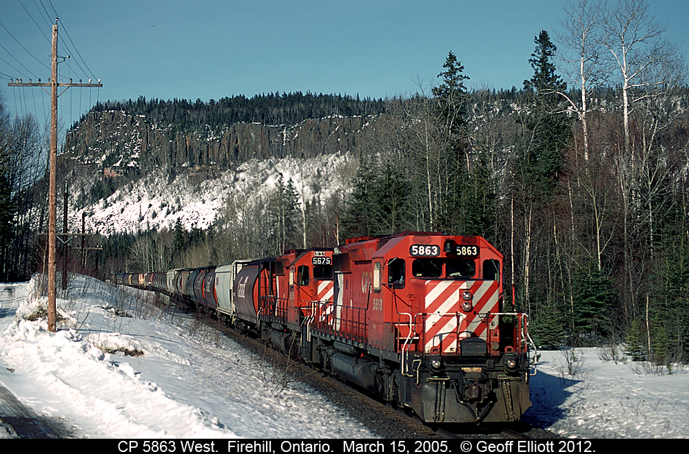 CP 5863, one of CP's last few large multimark scheme units left at the time, leads a train dubbed "Q-ARM" by the lineup, near Fire Hill, Ontario back on March 15, 2005.  This train is moving a large Canadian Forces Unit to BC for training, but as you can see by the picture, CP decided to add in a large cut of empty grain hoppers ahead of the Military equipment as part of the move paid for by our Canadian Tax dollars.