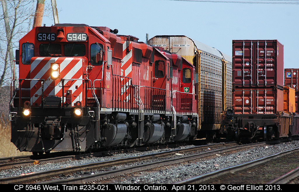 A CP SD40-2 trifecta on train #235-021, led by 5946, sits in the siding waiting for an eastbound container train to head out of Windsor on April 21, 2013.