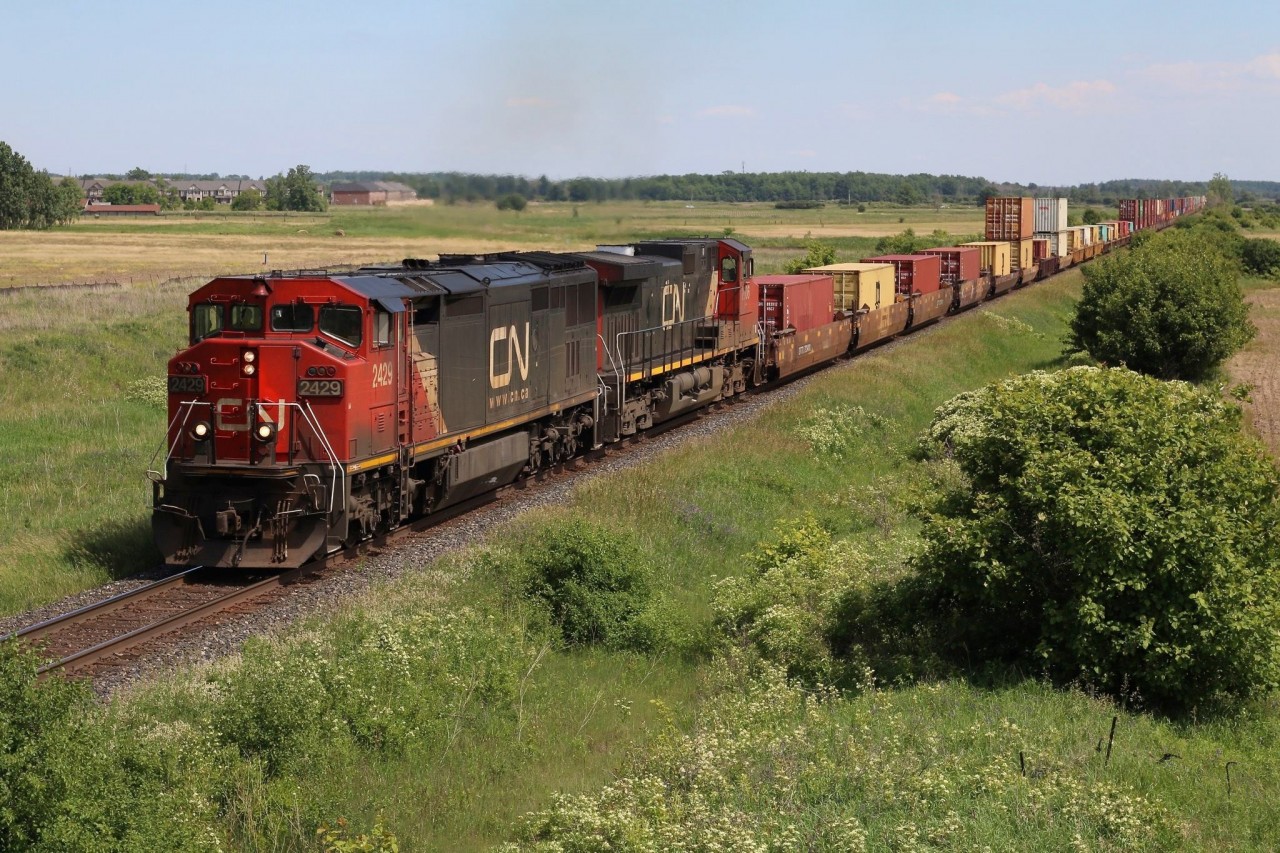 With 200 hundred new GE’s on order it seems now is the time to make the most of catching the old non-EVO locomotives. The Dash-8’s will surely be some of the first to go. CN’scowl body Dash-8’s are the last of the unique design similar to those built by EMD, GE and Bombardier, and will surely be missed. CN 2429 is one of the few that received the new company image a number of years ago and is seen assigned to stack train 148 as it heads eastbound through Milton.