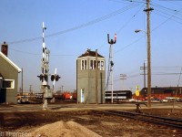 CN "London East" is pictured in March 1977, with the grade crossing tower that stood guard over Egerton Street featured prominently in the middle (new looking gates and crossbucks installed suggest its days are numbered though, and today it's long gone). Note the semaphore signals next to it, and the grey CN paint livery (with blue door) often seen on their lineside buildings and stations. In the background, various old MofW freight cars, orange-painted trucks, and other equipment can be seen in the yard.
