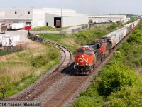 CN 2316 and 2671 pass the Whirlpool plant on their way to Mansewood.