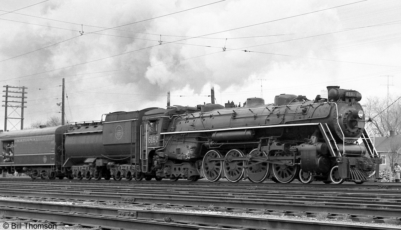 Canadian National U2e Northern 6167 is pictured early in its post-steam era fantrip excursion career, under the Oshawa Railway electric overhead catenary in Oshawa, July 8th 1961.