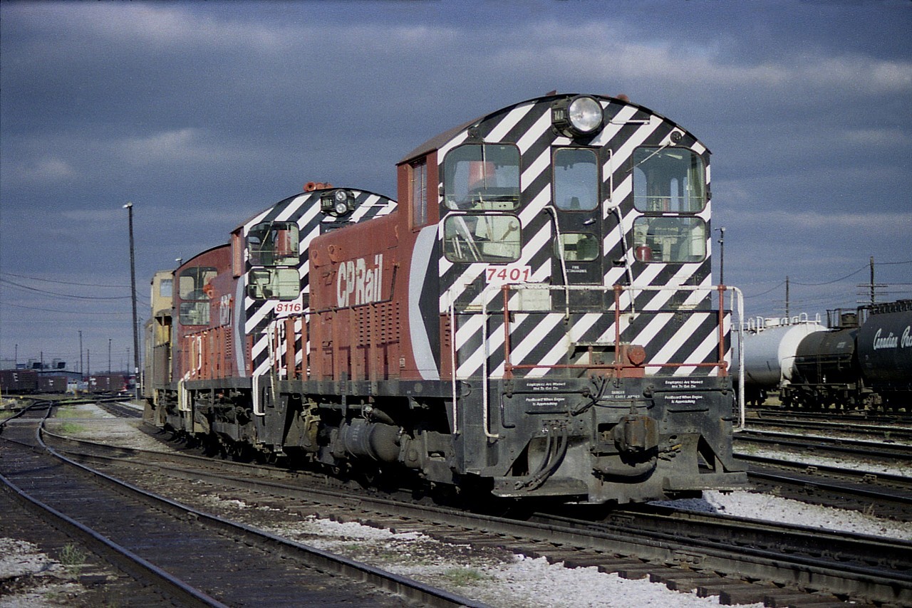 Under mostly threatening skies, a quick burst of sunshine meant a quick shot of CP switchers working Agincourt Yard. Seen are CP SW9 7401, SW1200RS 8116 and an unidentified third unit. (Note the difference in headlight) The 8116 is now retired and the 7401 was renumbered to 1201 in 1982 and dealt off to Rail Trust Equipment in 2003.