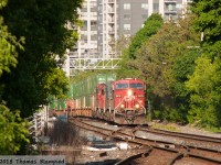 Through a canyon of tower blocks and trees, a yard transfer crosses over at Osler on its way to the Mactier Sub with 8876 leading CEFX 1037 and CP units 6223 and 9658.