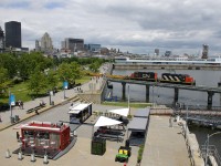 GP9's CN 4135 & CN 7228 lead a 50-car transfer out of the Port of Montreal, with the lead unit letting out some smoke as it crosses the Lachine Canal.