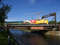 VIA 916 has a lager 'VIA 40' wrap on its long hood than other similarly wrapped VIA Rail P42DC's and here it leads VIA 22 over the Lachine Canal in Montreal.