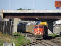 	CN 401 with CN 5738 & CN 8802 lead CN 401 is crossing from the north track to the fright track at Turcot West. These tracks will be no more in not too long a time, with CN's main line moving a bit further north due to highway construction in the area (some seen above the train).
