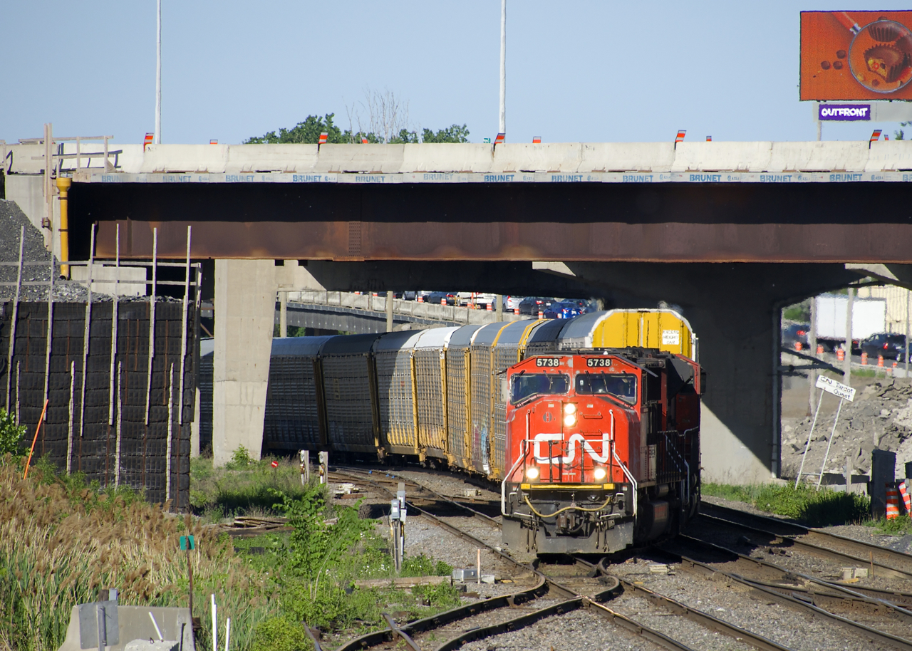 CN 401 with CN 5738 & CN 8802 lead CN 401 is crossing from the north track to the fright track at Turcot West. These tracks will be no more in not too long a time, with CN's main line moving a bit further north due to highway construction in the area (some seen above the train).
