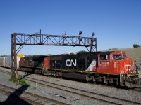 CN 401 with CN 5738 & CN 8802 lead CN 401 under a classic signal bridge which is living on borrowed time. Already signals have been removed over the transfer and freight track at left, those over the north and south track at right are sure to follow. At left is a track leading to what will be CN's new right of way in the near future. 
