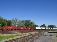 CP F94 is comprised of CP 3024, CP 4428 & CP 2205 and 22 cars as it passes the Lasalle Yard, on its way to serving clients on the Lacolle Sub on a gorgeous morning.