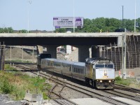 VIA 67 has wrapped VIA 6416 leading and unwrapped VIA 6404 with five LRC cars in between as it passes Turcot West.