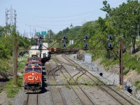 CN 120 has a trio of gevo's (CN 2274, CN 2990 & CN 2969) up front and CN 8937 mid-train as it exits Taschereau Yard after setting off and lifting cars in the yard. 