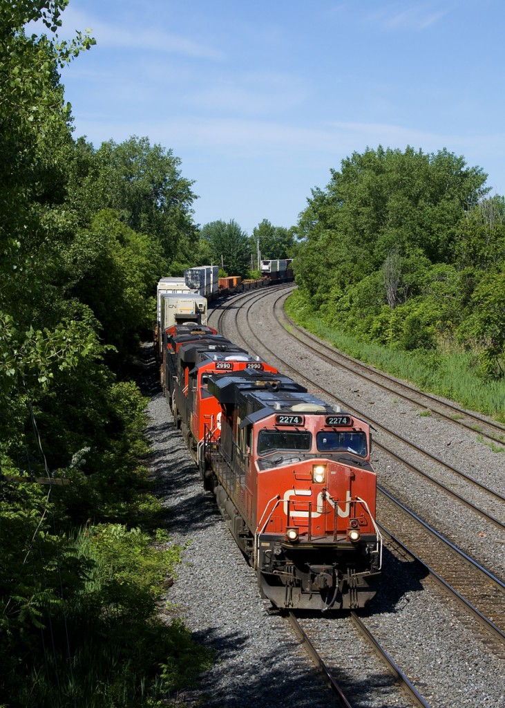 CN 120 has a trio of gevo's (CN 2274, CN 2990 & CN 2969) up front and CN 8937 mid-train as it rounds a curve in the Ville St-Pierre neighbourhood of Montreal.