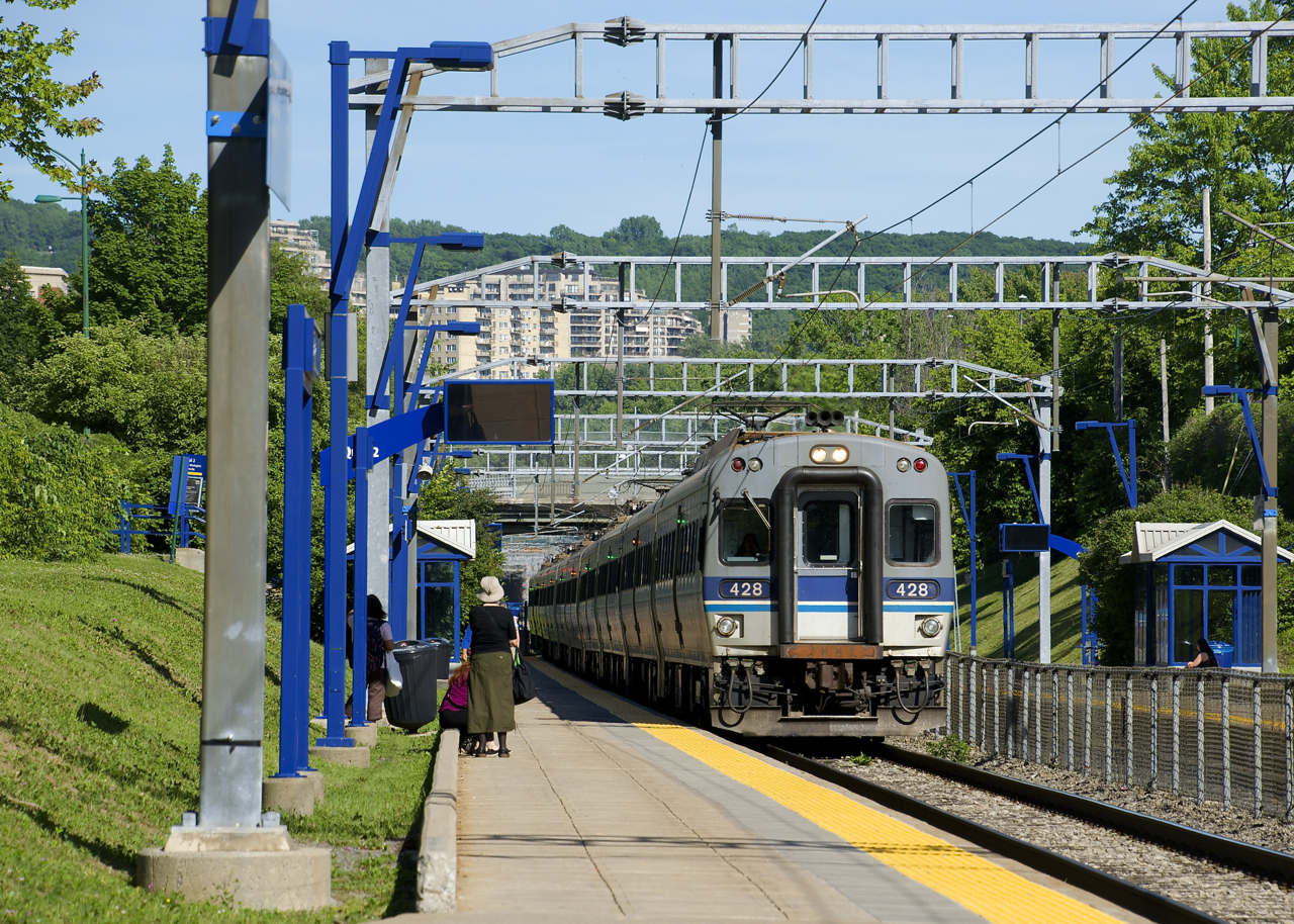 RTM 945 is about to leave Mont-Royal Station with a set of ten MR-90 cars. In the background is the stations namesake mountain; a few minutes earlier this train had exited a tunnel that brought it under Mount Royal.