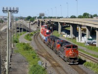 Up until around the end of 2017, the westbound lanes of autoroute 20 would be visible in the upper right of this scene, with the eastbound lanes at right, but the westbound lanes have since been demolished and shifted a bit further north. Here CN 120 swings under the eastbound lanes (which I will believe will move as well) with CN 8814, CN 2630 & CN 8812 up front and CN 2239 mid-train. Beside the head end power the switch is still in place for the Lachine Spur, though the spur has been pulled up since the end of 2015.