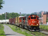 CN 5430 & CN 2620 lead CN 324 through the St-Henri neighbourhood of Montreal as they head towards St. Albans, Vermont with 62 cars to interchange to the NECR.