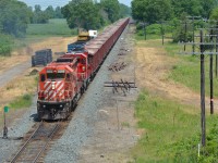 CP's GPS ballast train, now running late and has a straight shot to Windsor, continues West along side Caradoc siding after dumping at the far end of the siding. To the right I believe was the location of the old station. Does anyone have confirmation or pictures from the past? :)
