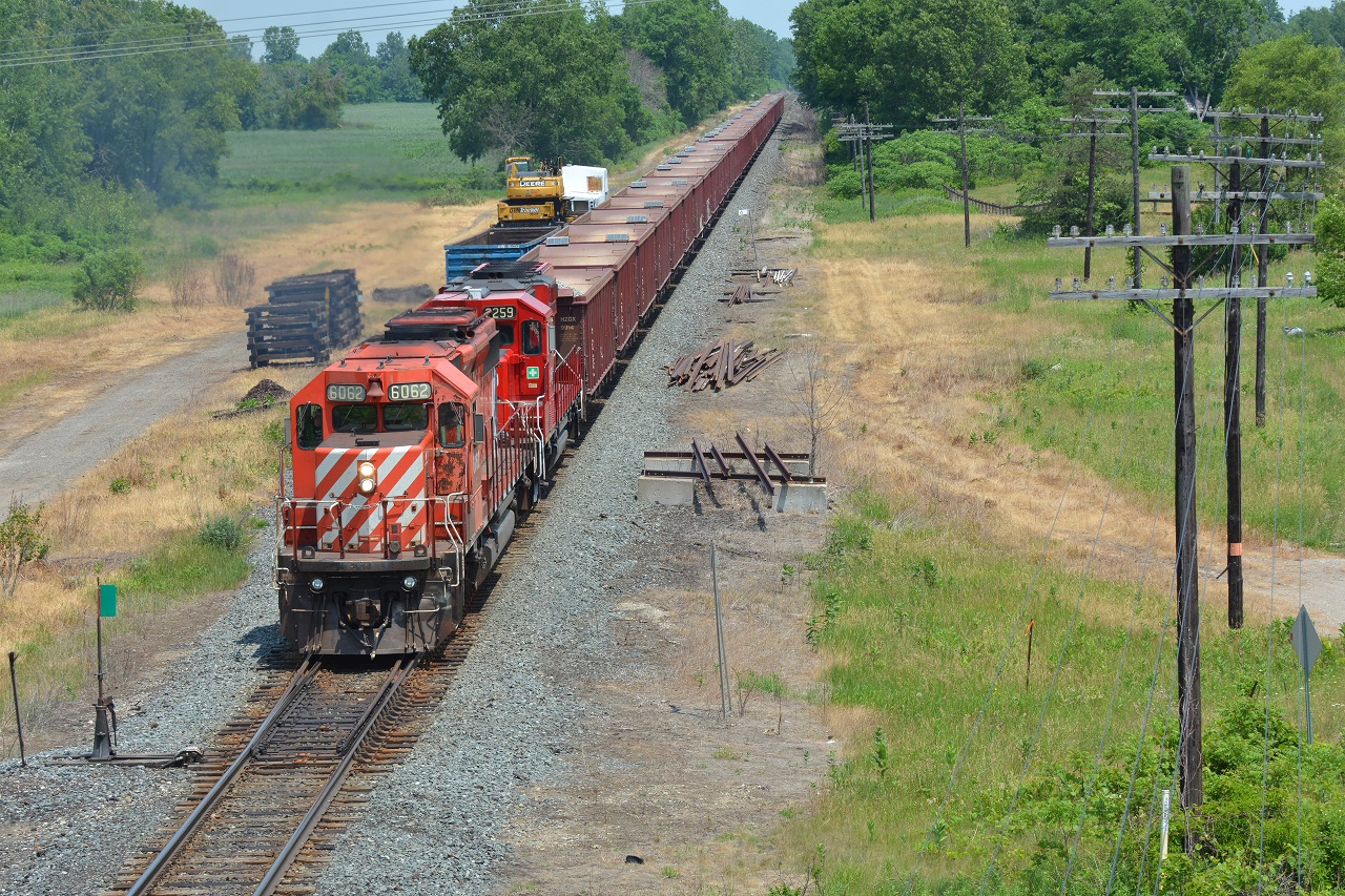 CP's GPS ballast train, now running late and has a straight shot to Windsor, continues West along side Caradoc siding after dumping at the far end of the siding. To the right I believe was the location of the old station. Does anyone have confirmation or pictures from the past? :)