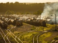 <b>Evening Tones and Burnt Dino Bones</b>
A trio of EMDs fill the evening air with diesel exhaust as the sun sets over CN's Stuart Street yard in Hamilton, Ontario.