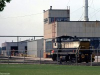 GMD shop switcher 113 (one of the former EMD demo SW1500 units) is pictured outside the GMD London locomotive assembly plant, outfitted with buffers to handle new <a href=http://www.railpictures.ca/?attachment_id=33555><b>SNTF Algerian export locomotives</b></a> under construction (one is visible inside the plant).
<br><br>
Built in 1971 was a demo unit and formerly used as a shop switcher at EMD's La Grange IL plant, the 113 only lasted about two years as a shop switcher at London before it was traded with Essex Terminal Railway (and became ETR's 107) for their <a href=http://www.railpictures.ca/?attachment_id=33661><b>SW8 102</b></a>, due to issues with tight trackage at the plant.