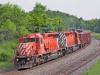 <b>Birthday Present</b> An empty Herzog ballast train heads up the MacTier hot on the heals of CP 421 with a pair of reactivated multimarks. Well worth the chase for machines that returned to earn their keep on the CPR.