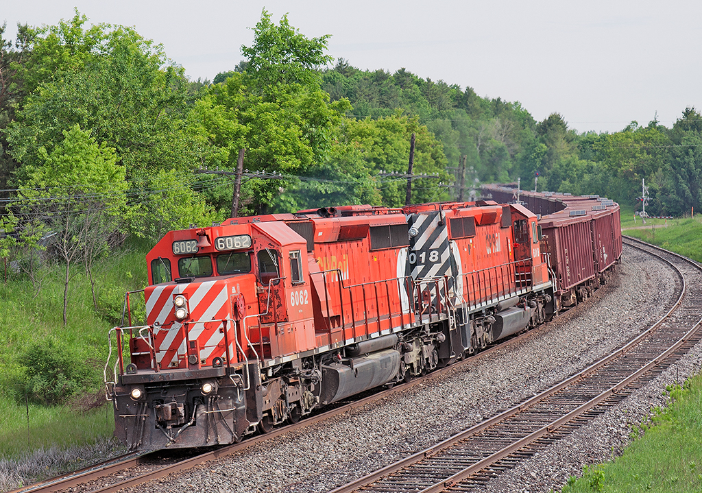 Birthday Present An empty Herzog ballast train heads up the MacTier hot on the heals of CP 421 with a pair of reactivated multimarks. Well worth the chase for machines that returned to earn their keep on the CPR.