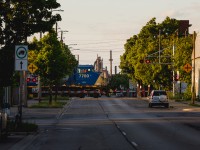 This (former) CSX GE C40-8W and the steel mills in the background set a scene that looks more like Illinois than Ontario. Nonetheless, GECX 7700 is seen guiding CN train no. 330 across Sherman Avenue on a pleasant June evening in Hamilton, Ontario.