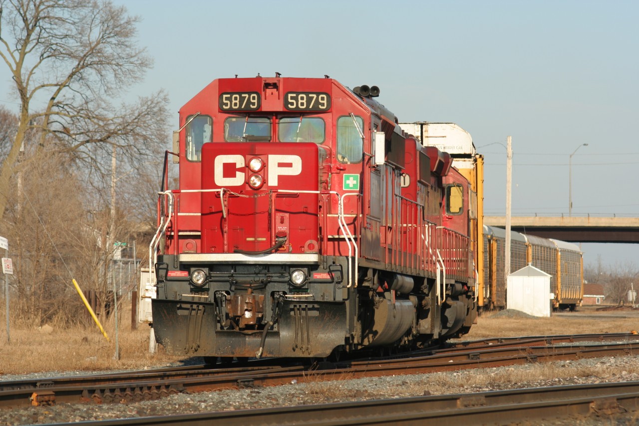 Canadian Pacific train T69 is seen departing Galt, Ontario as it enters the mainline with SD40-2's 5879/ 6601 after lifting auto racks from the Toyota facility.