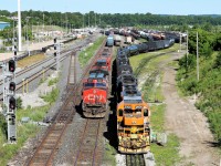 CN 2555 rolls up beside Quebec Gatineau 2500 (SOR) after setting off a few cars in the siding to return to the main track to retrieve the rest of its train.