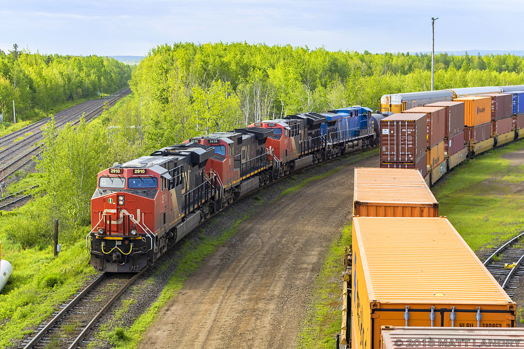 The yard crew brings the head end of CN 305 up near the switch at the west end of Gordon Yard. Inbound train Q120, seen on the right, hasn't cleared the switch yet. Yard crew ties the train down, and the crew for 305 will soon come on duty and finish the job before heading west.