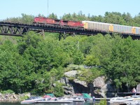 A northbound CP train with AC4400CW's 9680 and 8514, adorning the golden beaver paint scheme, crosses
the massive 1695 foot trestle bridge which was constructed during 1907 and stands 115 feet above the Seguin River and the Parry Sound Harbor.