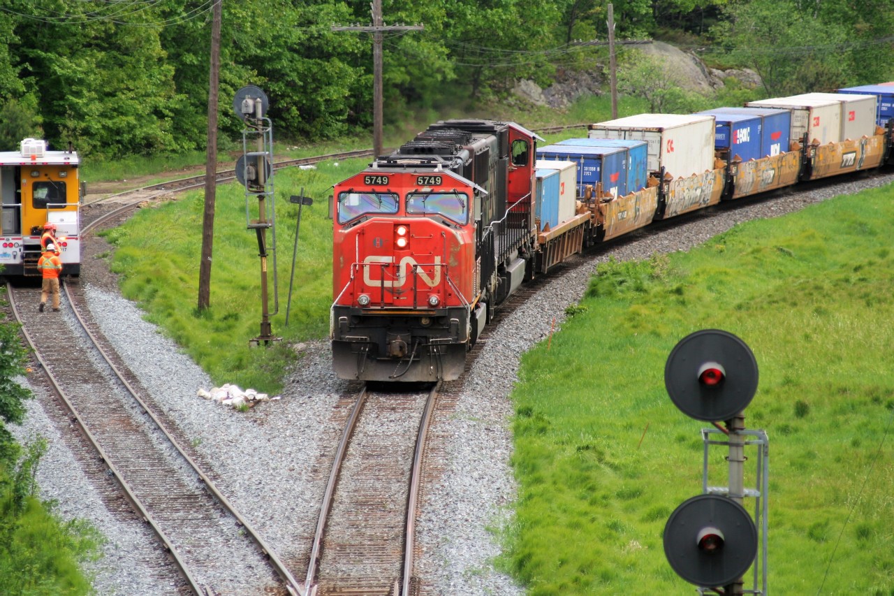 A foreman and his track equipment have cleared in the siding at Falding, Ontario to allow an intermodal train led by SD75I 5749 and a sister to continue their journey northward on the Bala Subdivision.