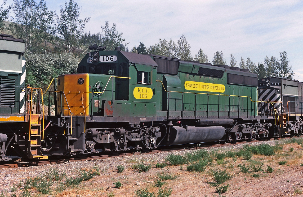 At Gibraltar, KCC 106 on it's new home railroad is wedged between two "two tone green" BCR MLW's. Eventually 106 will be overhauled and painted in the BC Rail red white & blue paint with a new number 741 although not equipped for lead cab standards. We were stopped there making a pick up copper concentrate.