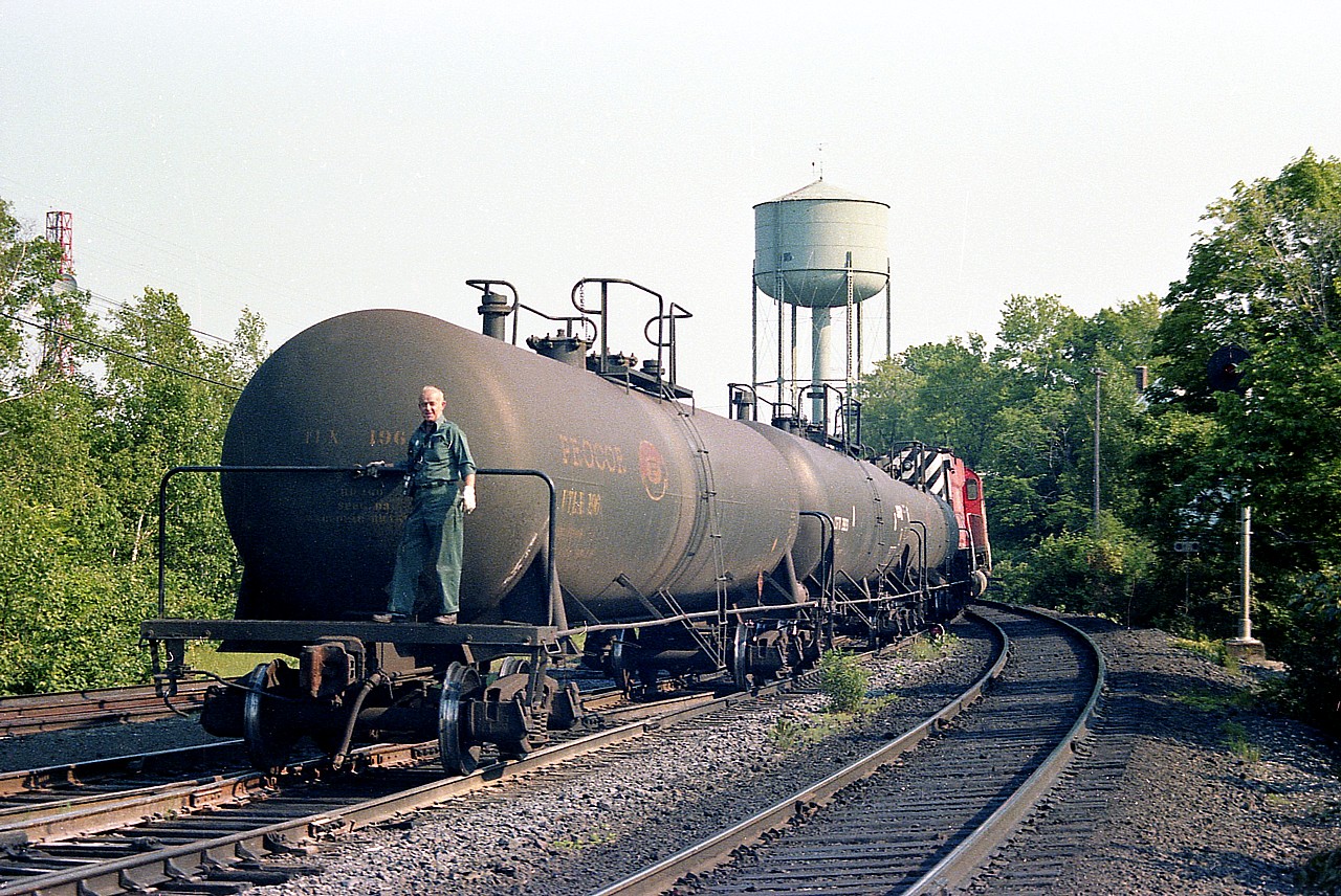 Looks like old time railroading already, but at the time it was just another day at Parry Sound CP station. I was killing the morning with agent Jimmy Bell when he turned and informed me that CP 4743 and 4719 was due in a few minutes, and they were going to set off cars in the yard. So I was able to grab this shot of tank cars right behind the head end power before the locos set them off and then backed down the main, picked up their train, and were off toward Toronto. Nothing like this goes on around there today. No industry, no industrial track (shared with CN) and not even any sort of yard left. The station, closed back in the early '90s, if I recall correctly, laid dormant for the vandals, but miraculously escaped destruction and now houses an Art Gallery. I am standing at the station shooting southwest in this image.