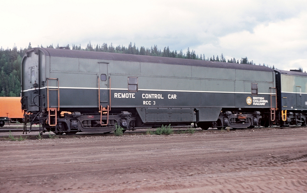 Remote Control Car at Prince George, BC Rail yard. Early 1970's BC Rail started to implement mid-train "robots" or remote control units. The railway purchased several RCC cars from CPR and the BN / GN. The RCC cars were made from CLC or EMD B units and contained the electronics and air brake equipment for Remote Control operations. The RCC's were basically the slave receiver and were MU'd to the locomotives in the remote consist and sent the signals to the remote units in the consist. Some of the RCC cars were equipped with a oil stove heater, cot bunk  and electric hotplate for use by any technician that may ride the RCC cars during the experimental stage of remote control operations. RCC 3 pictured is ex CPR from a CLC "B" unit